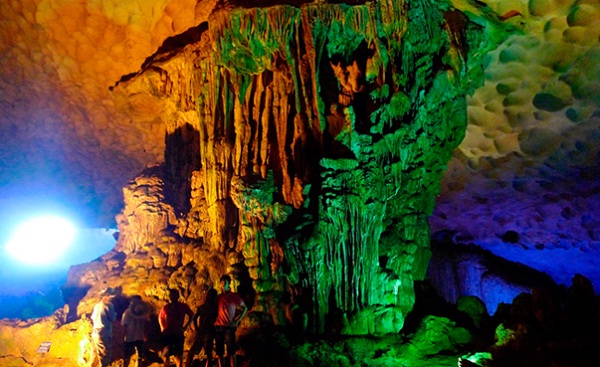  Colorful lights reflected on rock walls in Dau Go Cave
