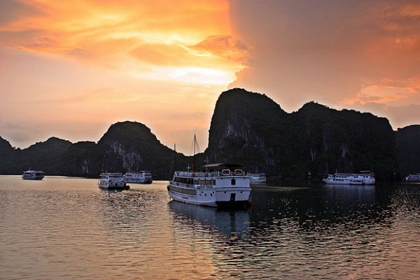 Enjoy stunning sunset on our luxury cruise on your trip to Halong Bay
