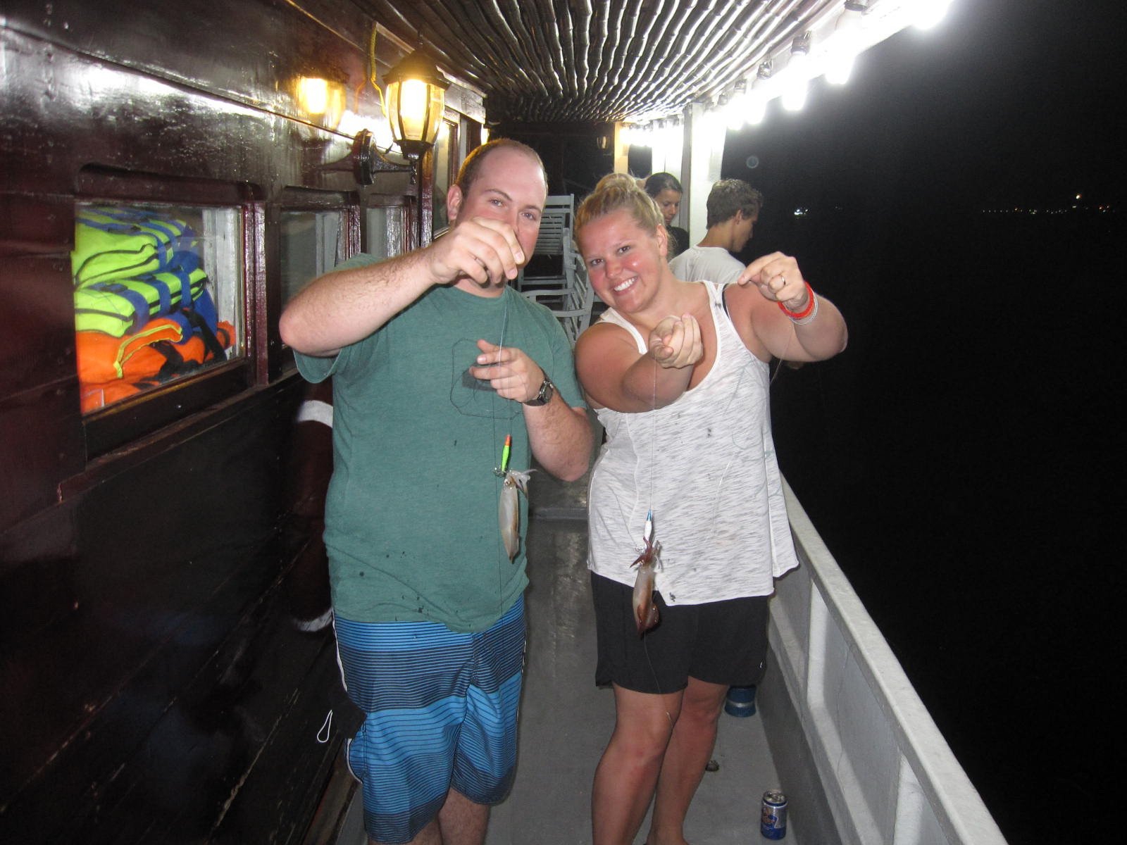 The happiness of visitors when fishing squids at night in Halong Bay