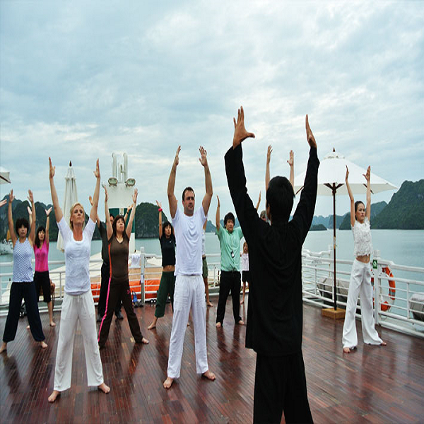 Tourists participate in tai chi activity at the break of dawn on Huong Hai Sealife